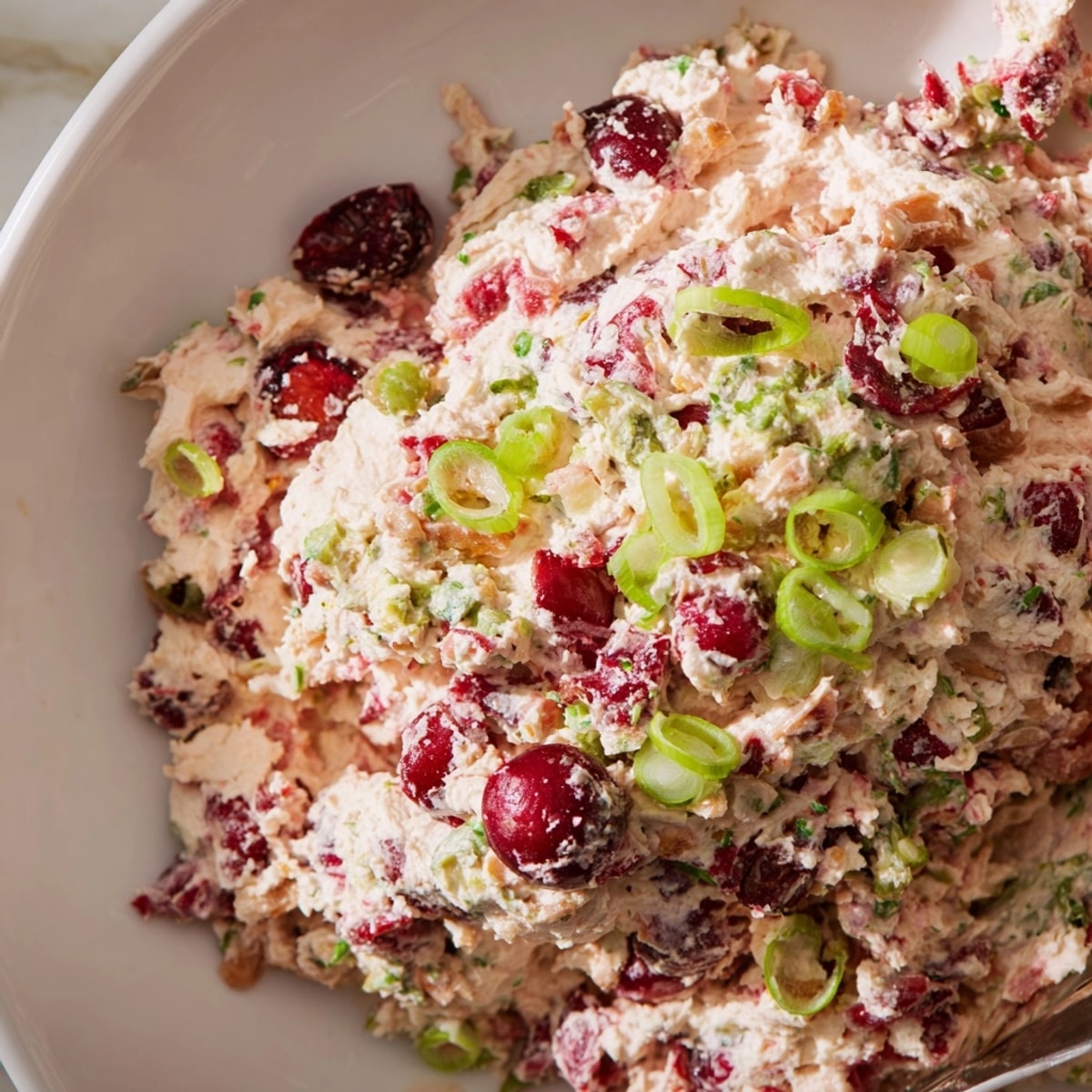 Vibrant Spicy Ginger Cranberry Jalapeño Dip, ready to serve with crunchy crackers.