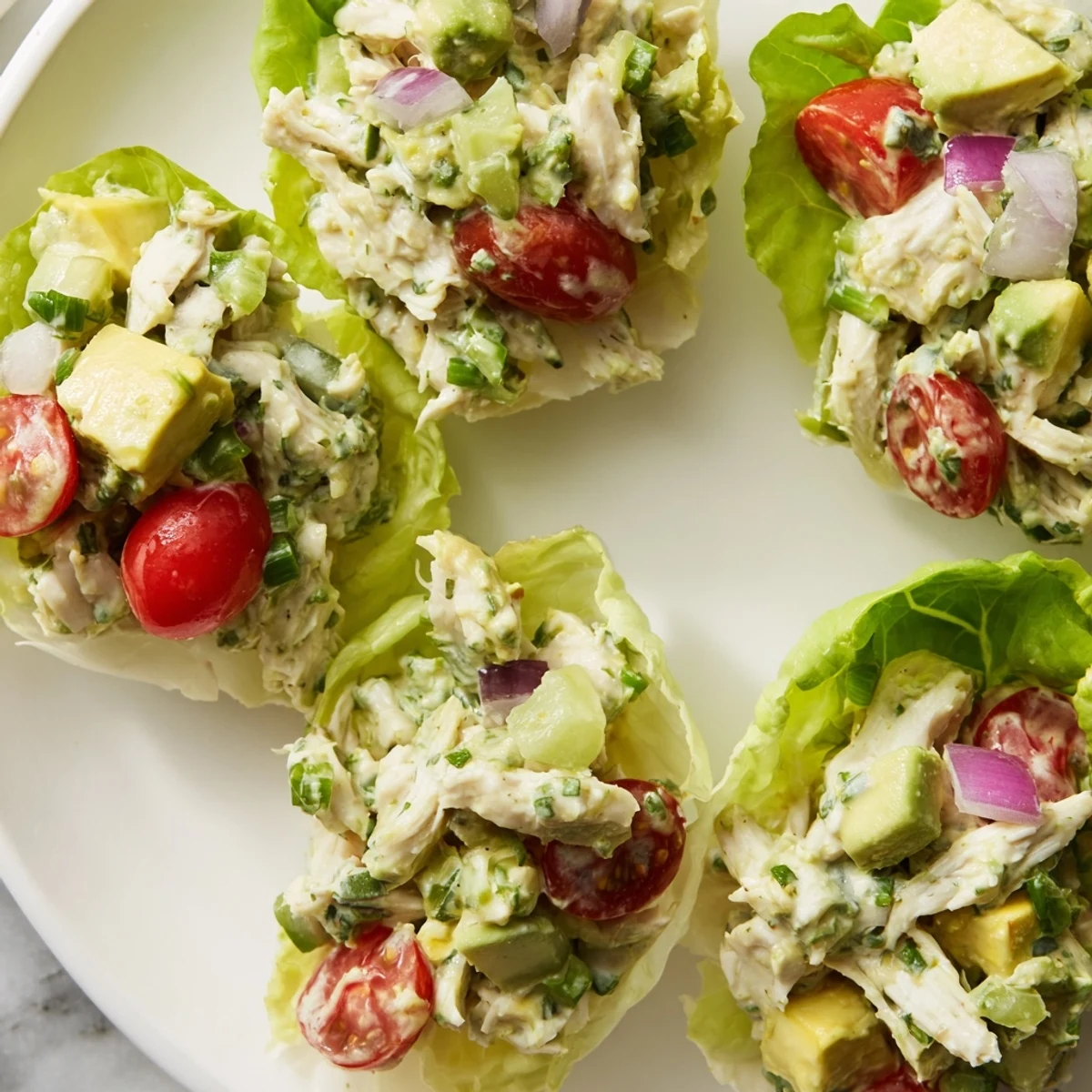 Zesty chicken salad made with avocado, served in crunchy lettuce wraps.