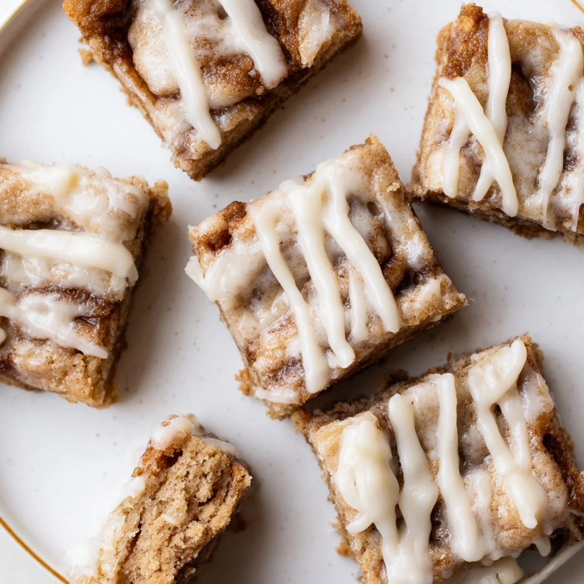 Soft Cinnamon Roll Cookie Bars topped with creamy glaze, perfect for dessert lovers.  
