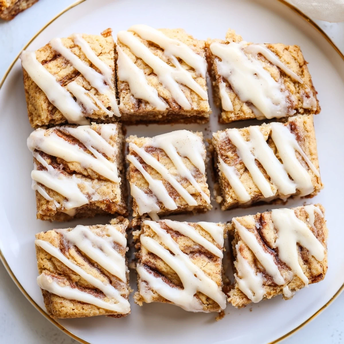 Warm, gooey Cinnamon Roll Cookie Bars ready to satisfy your sweet tooth cravings.