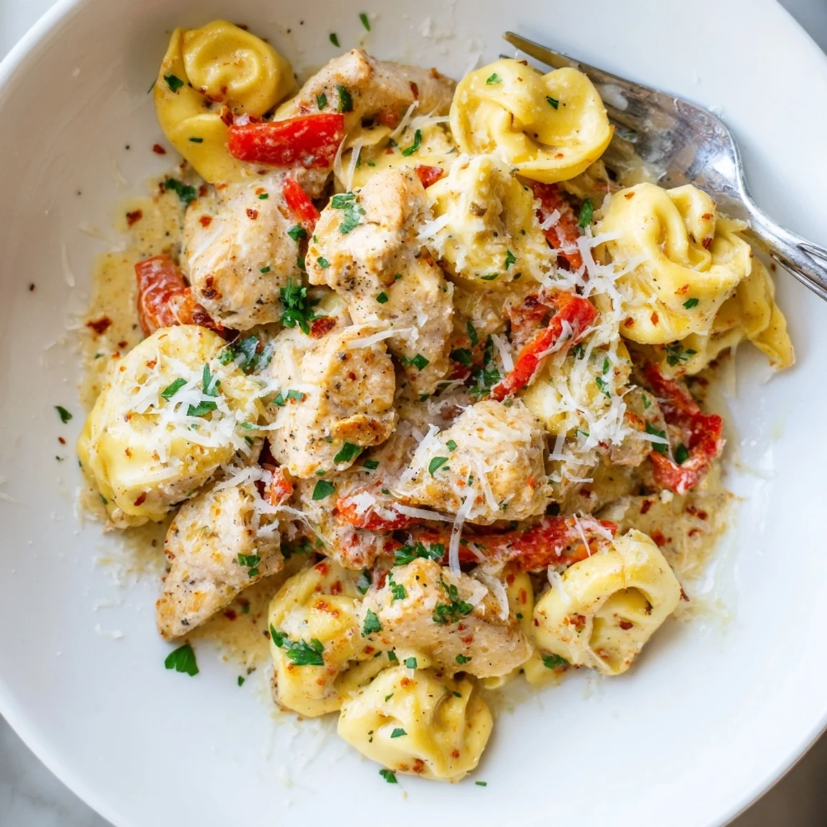 Zesty Cajun Garlic Parmesan Chicken Tortellini served in a creamy, flavorful sauce.  