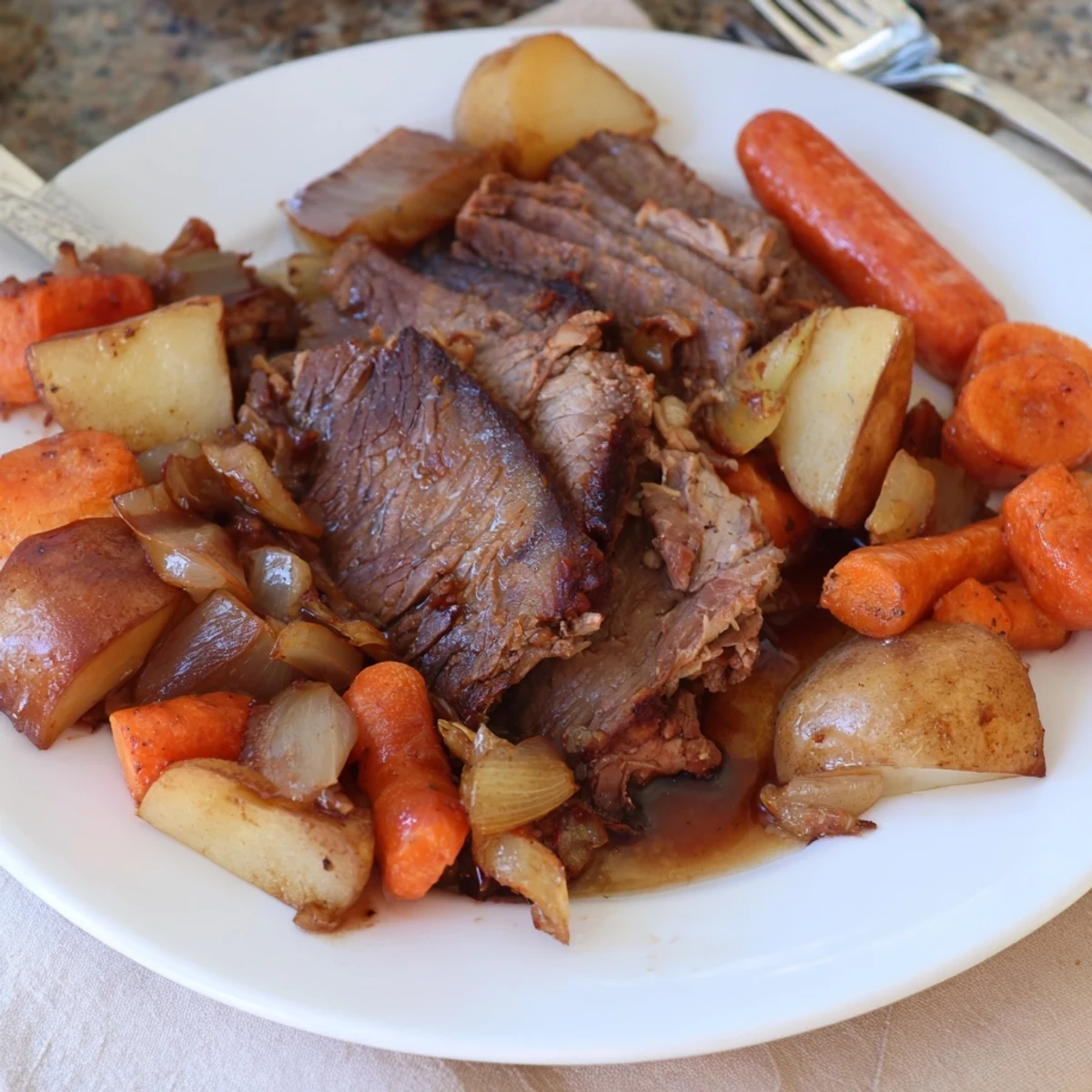 Golden-brown Sunday pot roast surrounded by tender, vibrant roasted vegetables on the plate.  