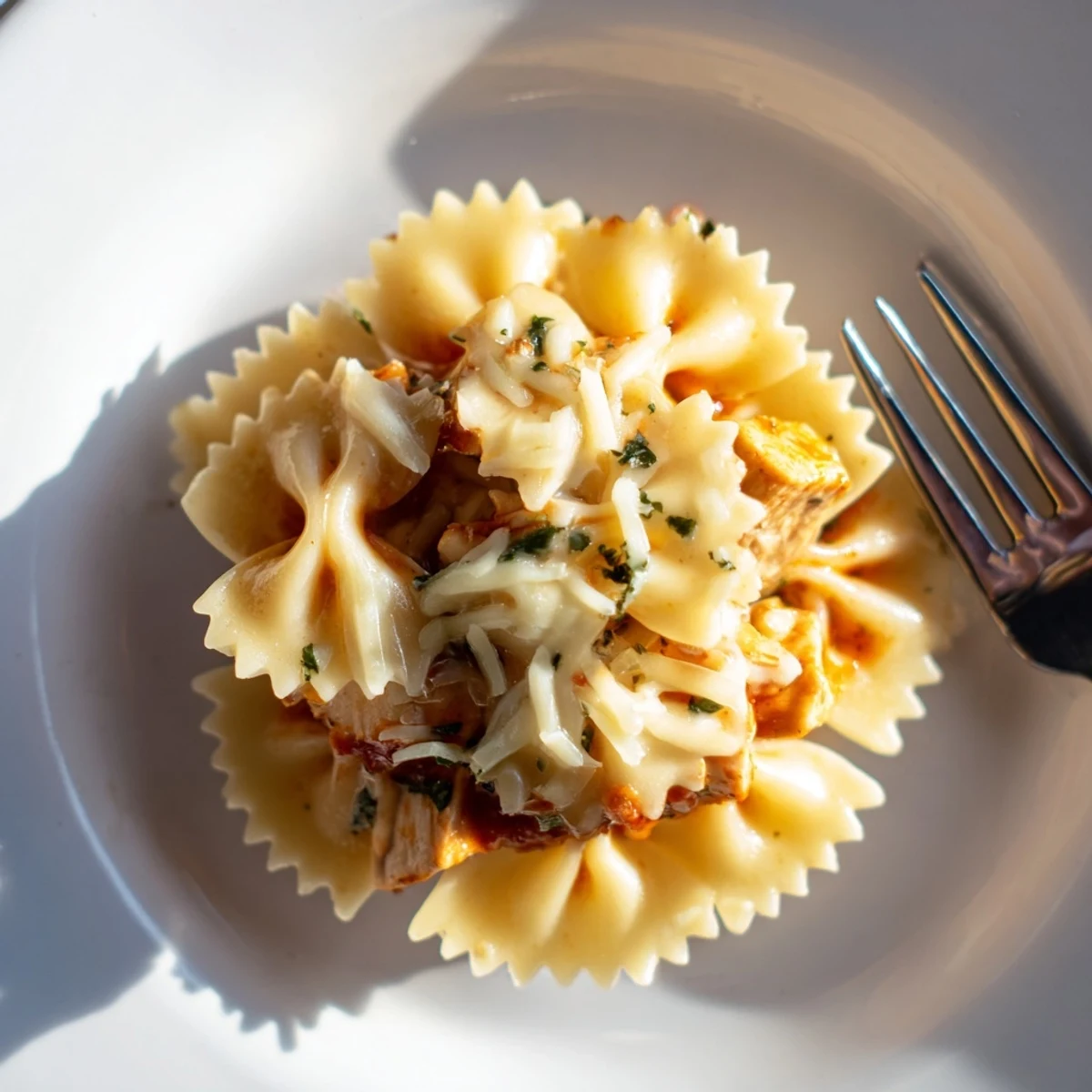 Tasty Mozzarella Garlic Butter Chicken Bowties topped with creamy, melted cheese and herbs.  