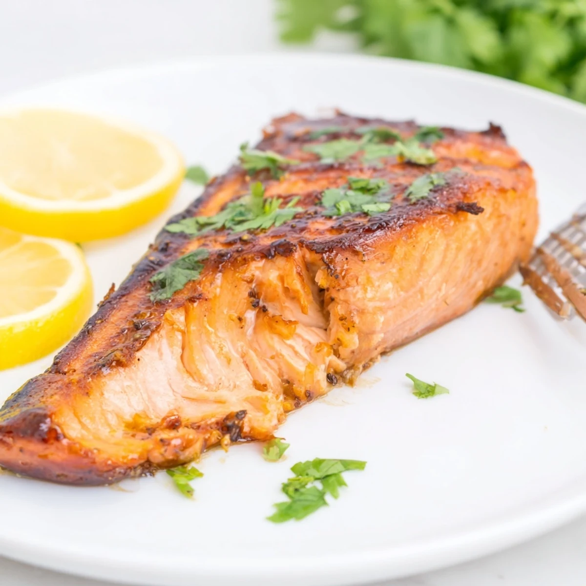 Juicy honey ginger grilled salmon glistening with a caramelized glaze, perfect for summer meals.  