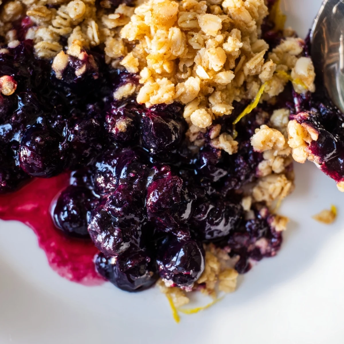 Irresistible blueberry & lemon crisp topped with ice cream, perfect for summer nights.