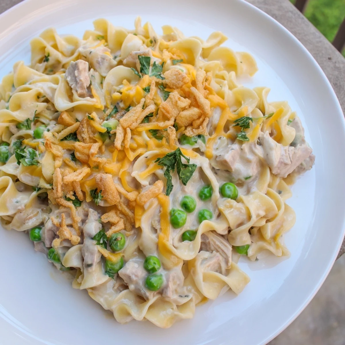 A bubbling Tuna Noodle Casserole with a crispy onion topping, perfect for a cozy weeknight meal.