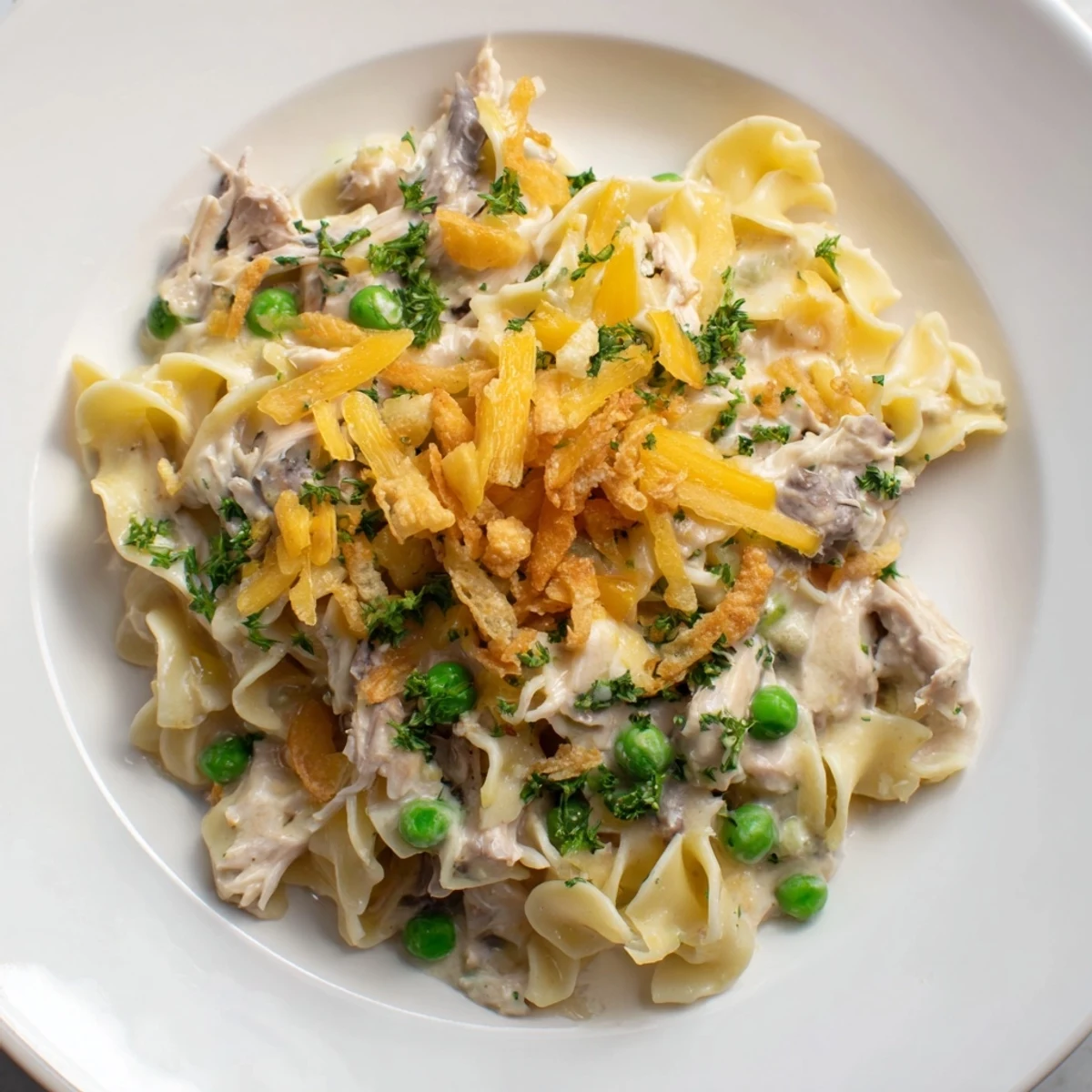 This creamy Tuna Noodle Casserole features a golden, crunchy topping and tender noodles with fish.