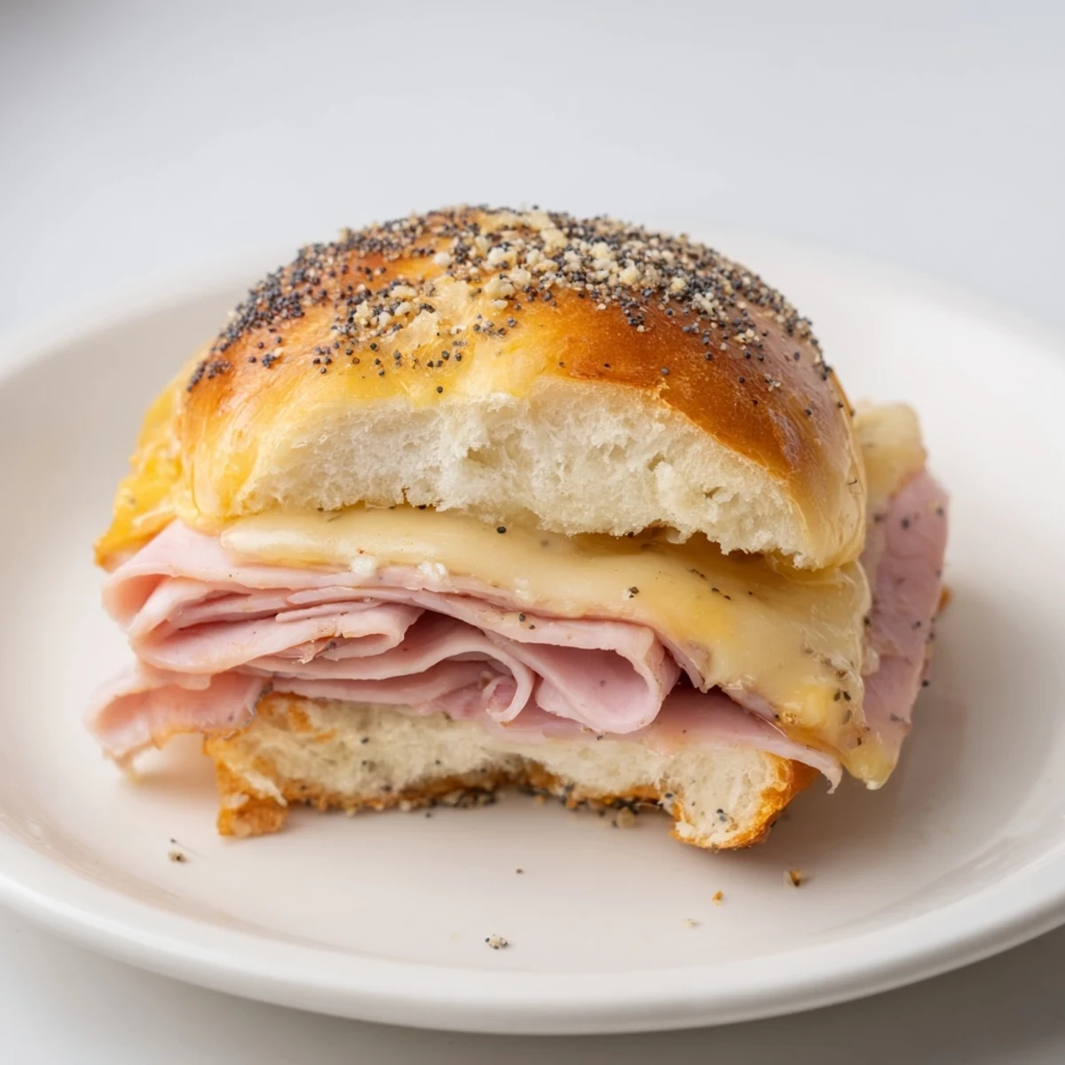 Warm, delicious Budget-Friendly Ham & Cheese Sliders sliced and ready to serve, perfect for a quick lunch.