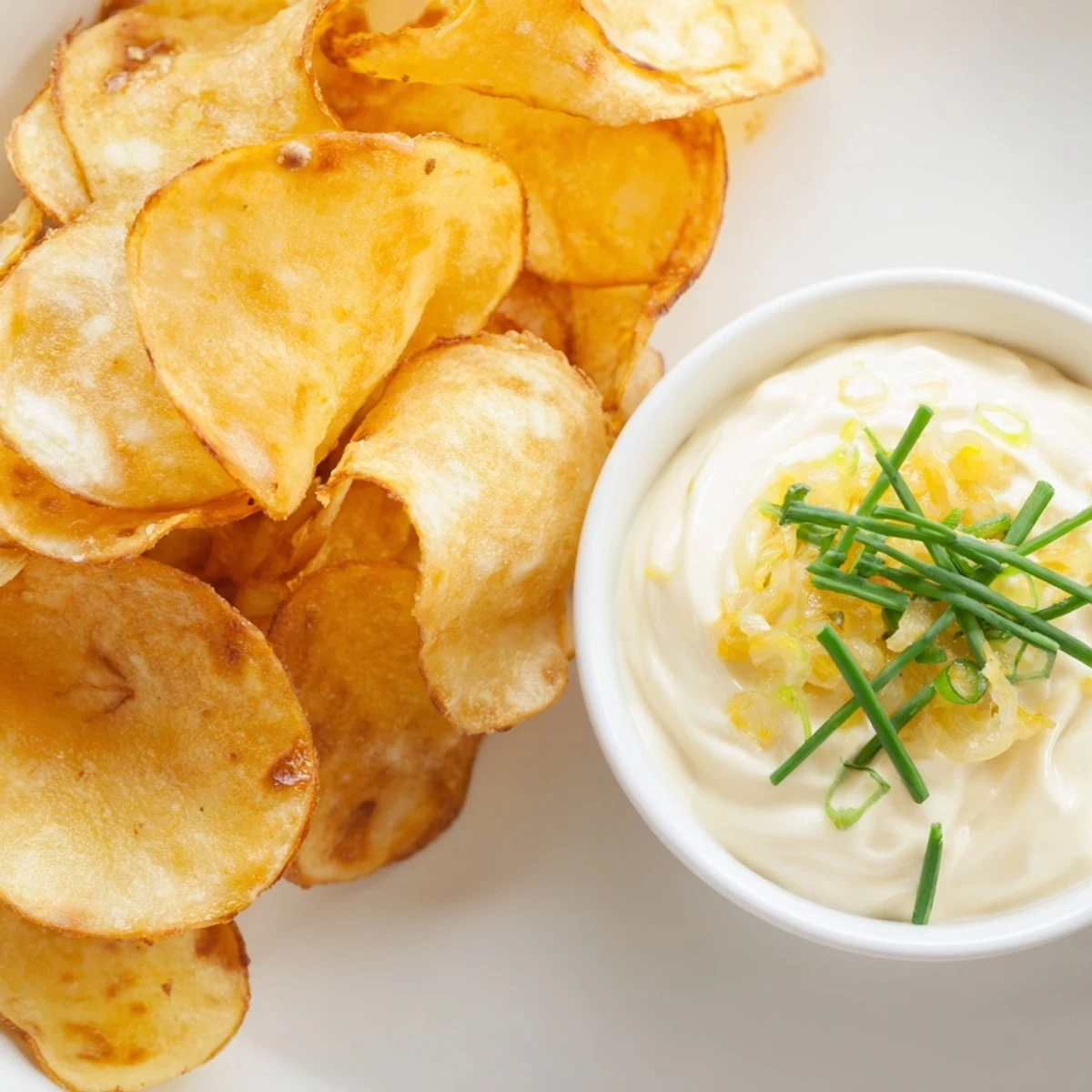 A close-up of potato chips with onion dip, a classic American snack perfectly portioned.