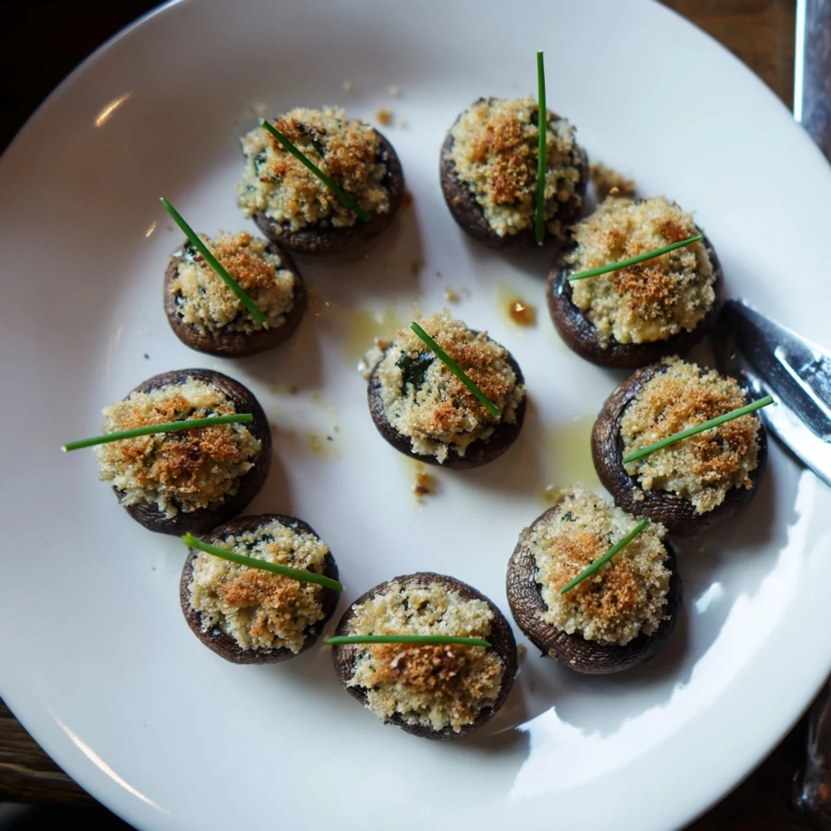Golden-brown stuffed mushroom caps arranged in ring, perfect for a flavorful appetizer.