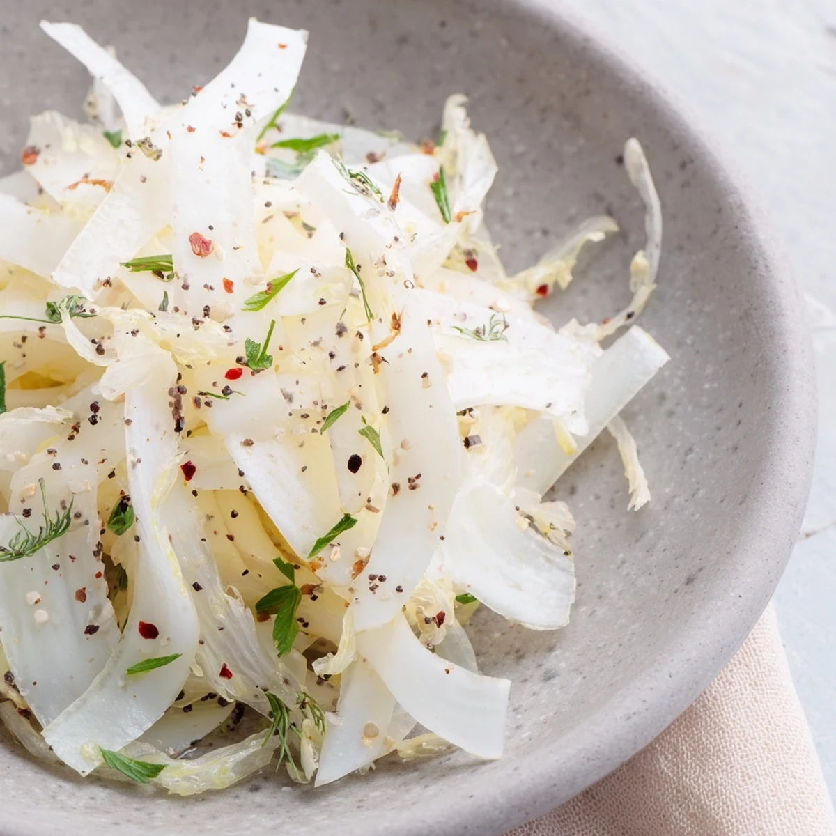 The Tundra Trek salad on a chilled stone plate, showcasing thinly sliced veggies and coconut flakes.