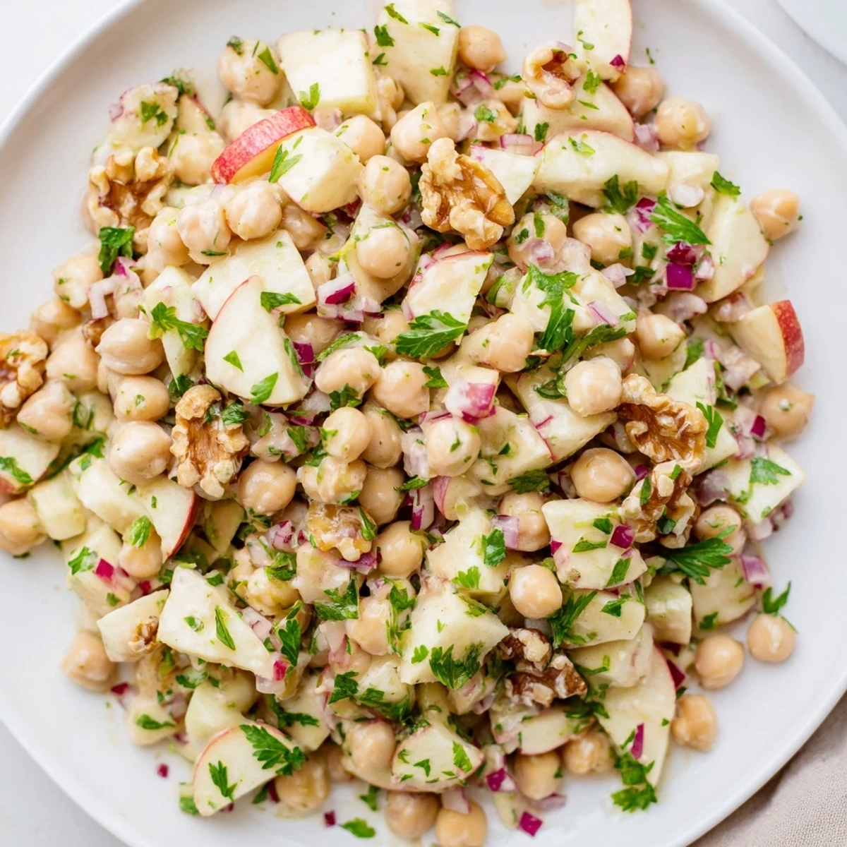 Freshly tossed Fall Harvest Apple and Chickpea Salad with a tangy honey-mustard dressing looks delicious.