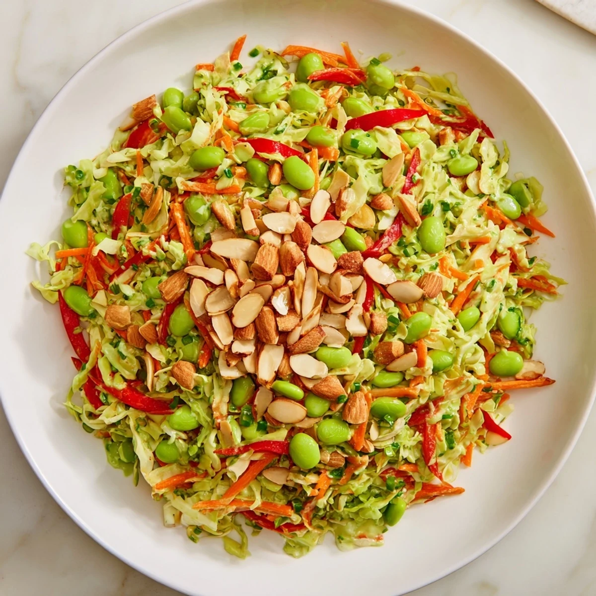 Crunchy Cabbage and Edamame Salad with vibrant colors and a creamy green dressing, ready to eat!