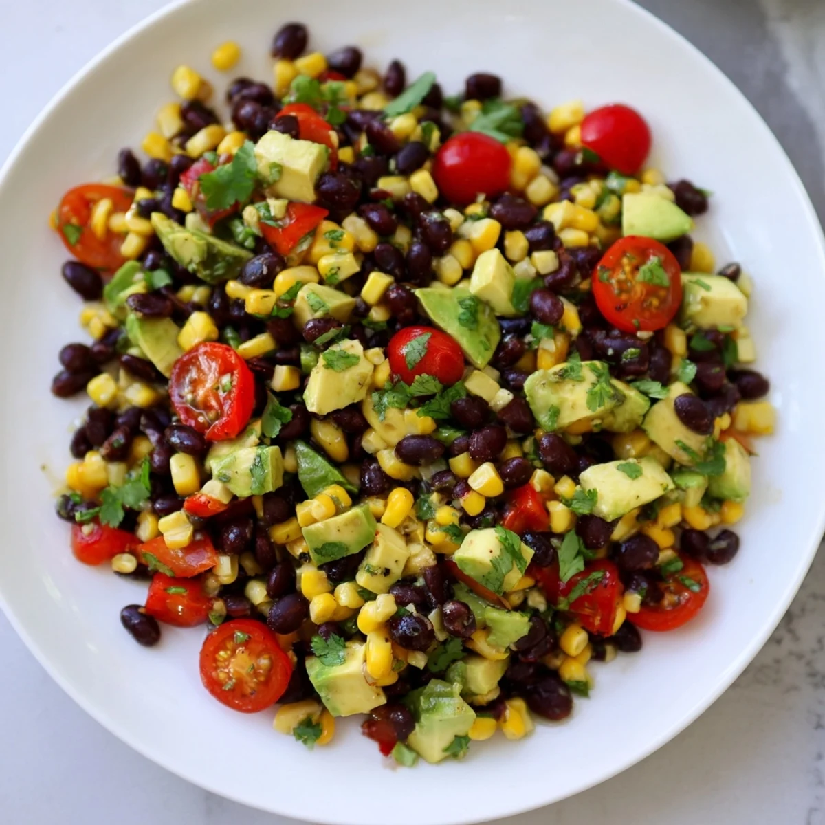 A colorful Southwestern Black Bean and Corn Salad, ready to serve with a zesty lime-cilantro dressing.