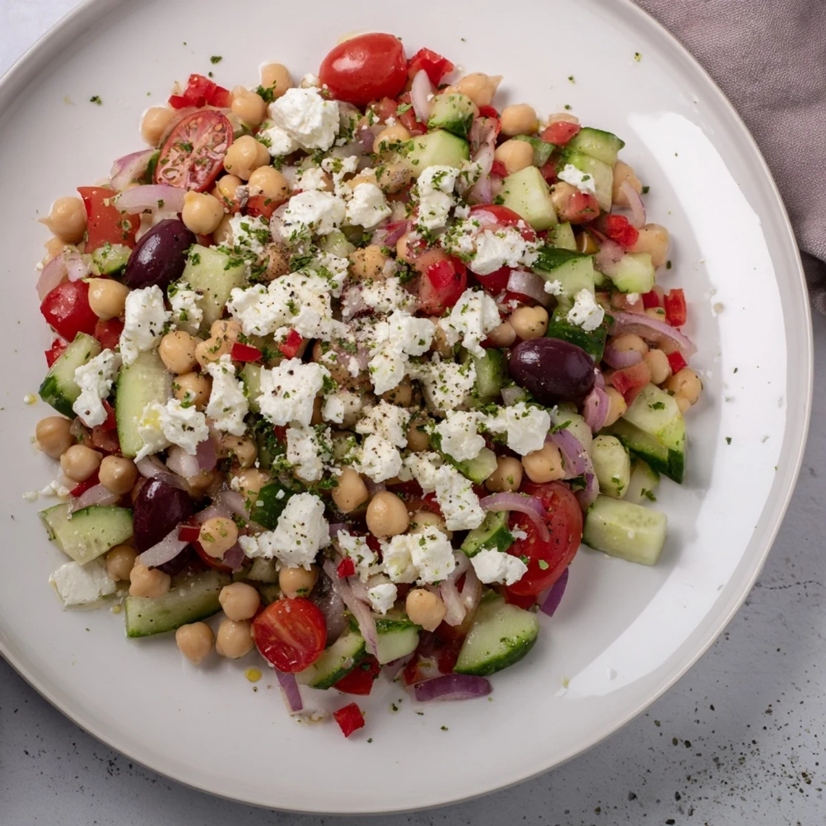 Vibrant Mediterranean Chickpea and Feta Bowl: A colorful mix of chickpeas, vegetables, and vegan feta, ready for serving.