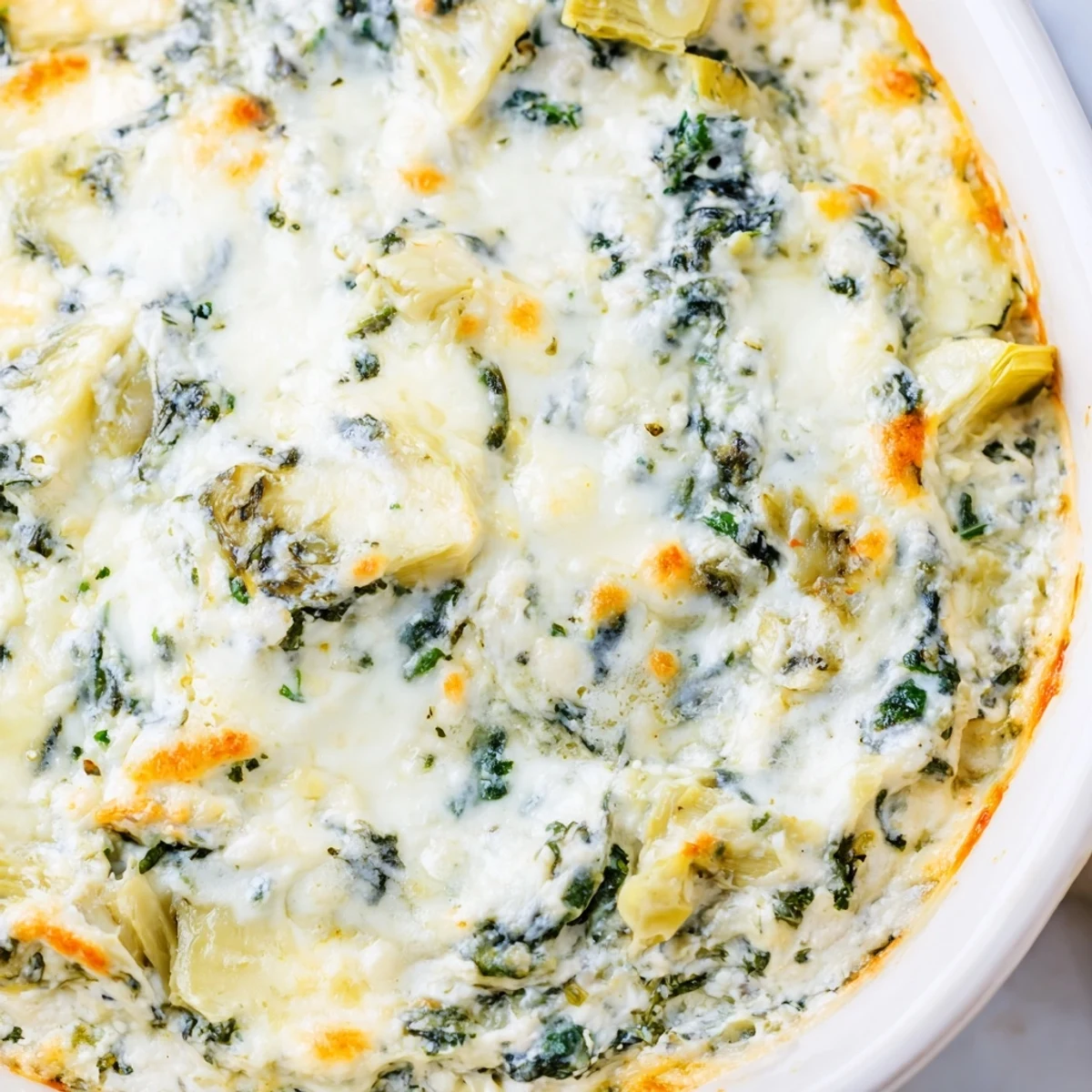 Fresh spinach and tender artichoke hearts baked with melted mozzarella and Parmesan in a savory appetizer.  