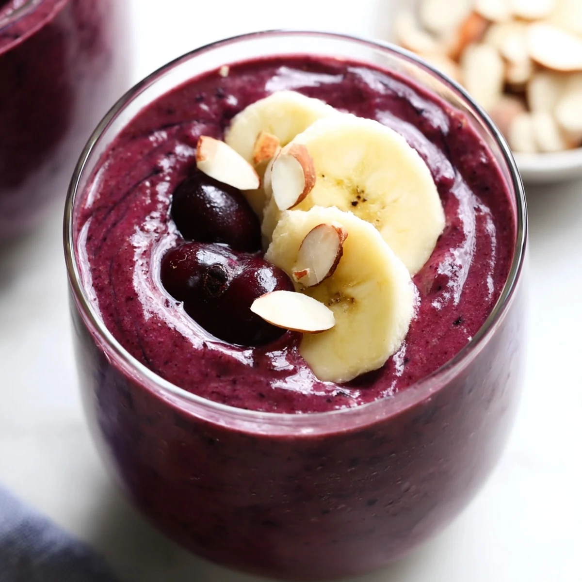 Blending frozen tart cherries and almond butter creates a luscious Cherry Almond Smoothie, an ideal cooling beverage for warm afternoons.