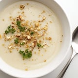 Creamy roasted celeriac soup served hot in a rustic bowl with a side of crusty bread.