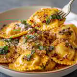 A plate of pasta with sauce and cheese.