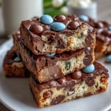 Colorful pastel M&Ms and Cadbury mini eggs stud these chewy cookie bars, making them a festive Easter dessert treat.
