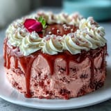 Elegant pink velvet cake with rosé, cream cheese frosting, and stylish gold drip.
