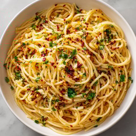 A bowl of pasta with red peppers.