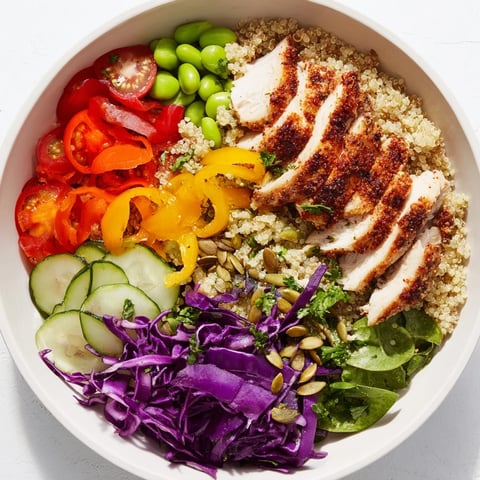 Vibrant healthy meal-prep bowls layered with colorful veggies and quinoa.  