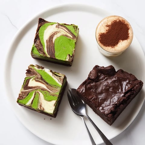 Delicious matcha-miso brownies cooling on a wire rack, showcasing vibrant green swirls.  