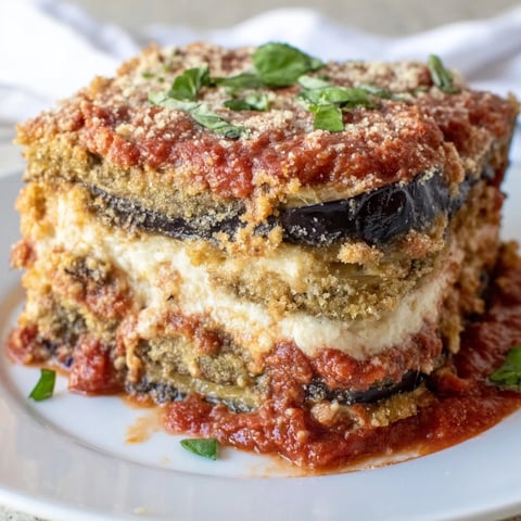 Golden Eggplant Parmesan Lasagna layered with rich marinara and creamy cheeses, perfect for family meals.  