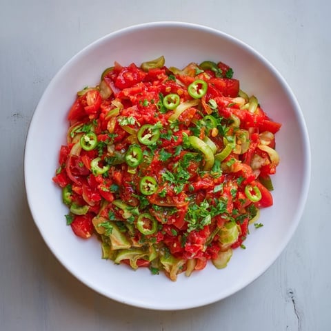 A colorful bowl of Pickle De Gallo Salsa, bursting with fresh tomatoes and zesty lime.
