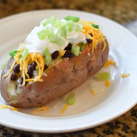 Golden, fluffy baked potato bar, ready to be customized with colorful, flavorful toppings.