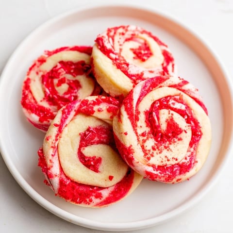 Swirling red and white Candy Cane Pinwheel Cookies, perfectly showing delightful, festive holiday treats.