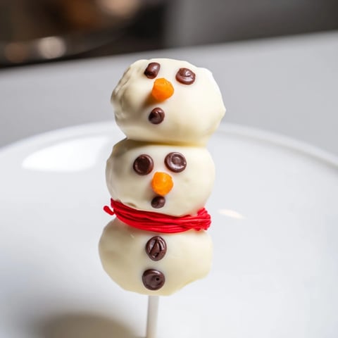 Festive Express Snowman Marshmallow Pops, dipped in white chocolate, ready for a winter treat.