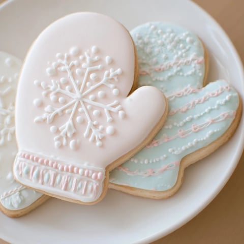 Warm & toasty mitten cookies display, perfect for winter, featuring beautifully frosted, colorful sugar cookies.