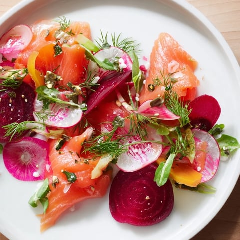 A beautifully arranged Winter Harvest Smoked Salmon Board with colorful roasted vegetables and creamy cheeses.