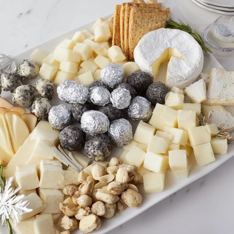 Elegant The Silver Screen cheese board, featuring truffle brie, chocolates, and grapes, perfect for movie night.