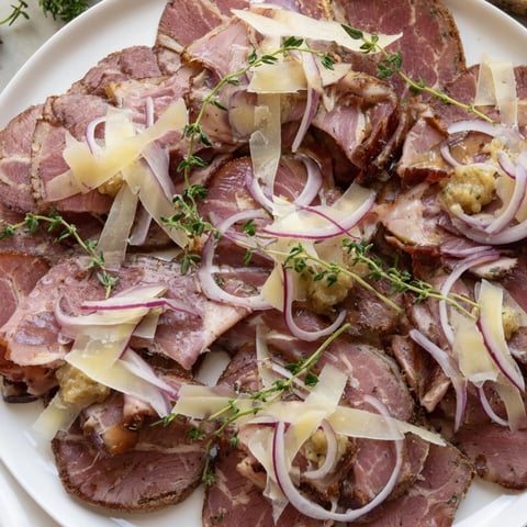 A beautifully arranged Burlap & Lace charcuterie board offers a delicious medley of cured meats and cheeses.