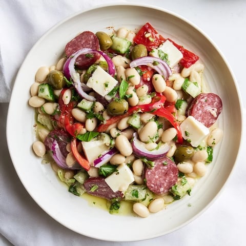 Italian Antipasto Bean Salad: A colorful bowl of chilled beans, salami, and provolone, ready to eat.