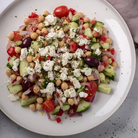 Vibrant Mediterranean Chickpea and Feta Bowl: A colorful mix of chickpeas, vegetables, and vegan feta, ready for serving.