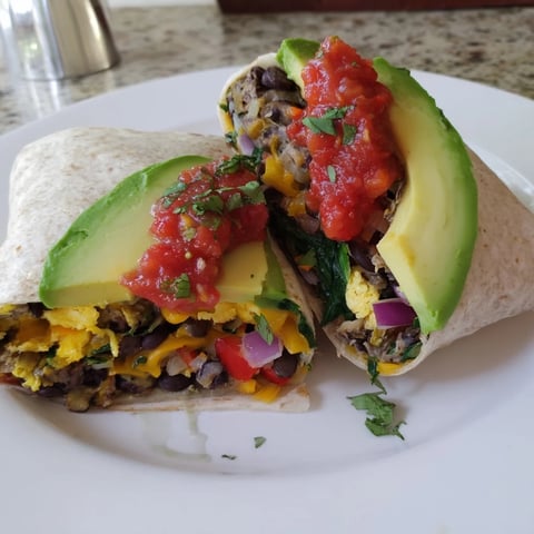 Warm, flavorful Veggie-Loaded Breakfast Burrito, perfectly assembled with fresh avocado and salsa.