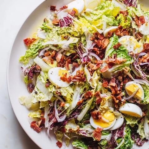 Close-up of Bitter Greens Salad with Warm Bacon Dressing, a savory, slightly wilted salad.