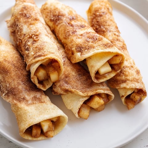Golden, flaky Apple Pie Roll-Ups fresh from the oven, ready to serve with caramel drizzle.