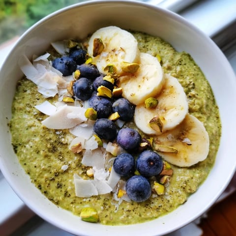 A chilled jar of matcha overnight oats, layered with creamy oats and fresh berries.