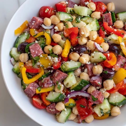 Vibrant Crunchy Antipasto Chopped Salad, brimming with colorful veggies, salami, mozzarella, and zesty Italian dressing.