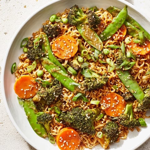 Steaming Ramen Noodle Stir-Fry Remix, loaded with colorful veggies, is ready for a quick weeknight dinner.