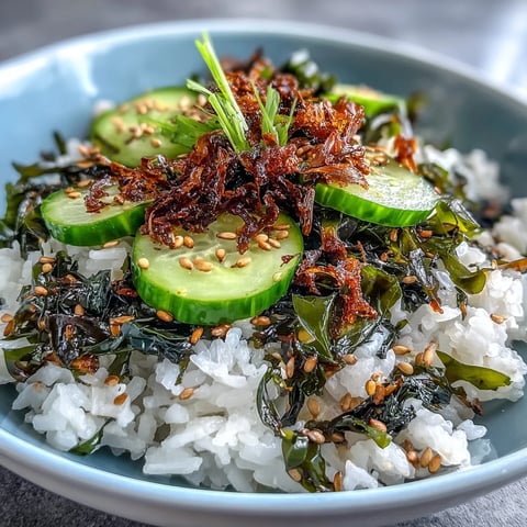 A close-up of the Seaweed & Nori Rice Bowl, featuring fluffy sushi rice topped with crisp cucumber slices and shredded nori.