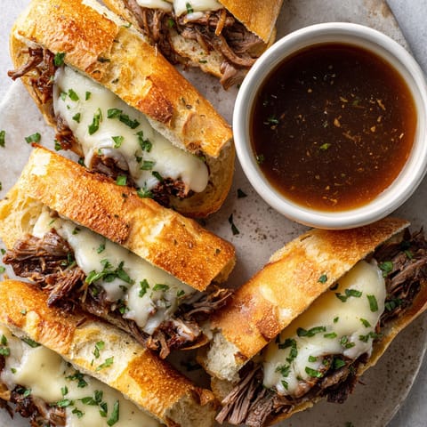 A plate of sandwiches with meat and cheese.