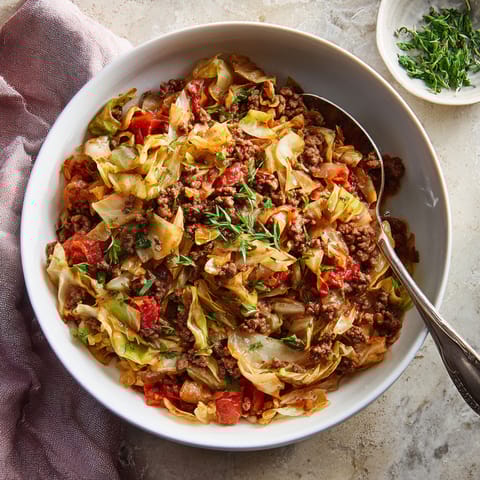 A bowl of food with a spoon in it.
