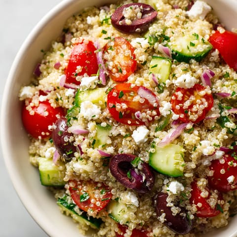 A bowl of rice with vegetables and feta cheese.