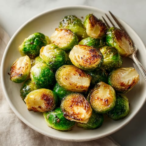 A plate of cooked brussel sprouts.